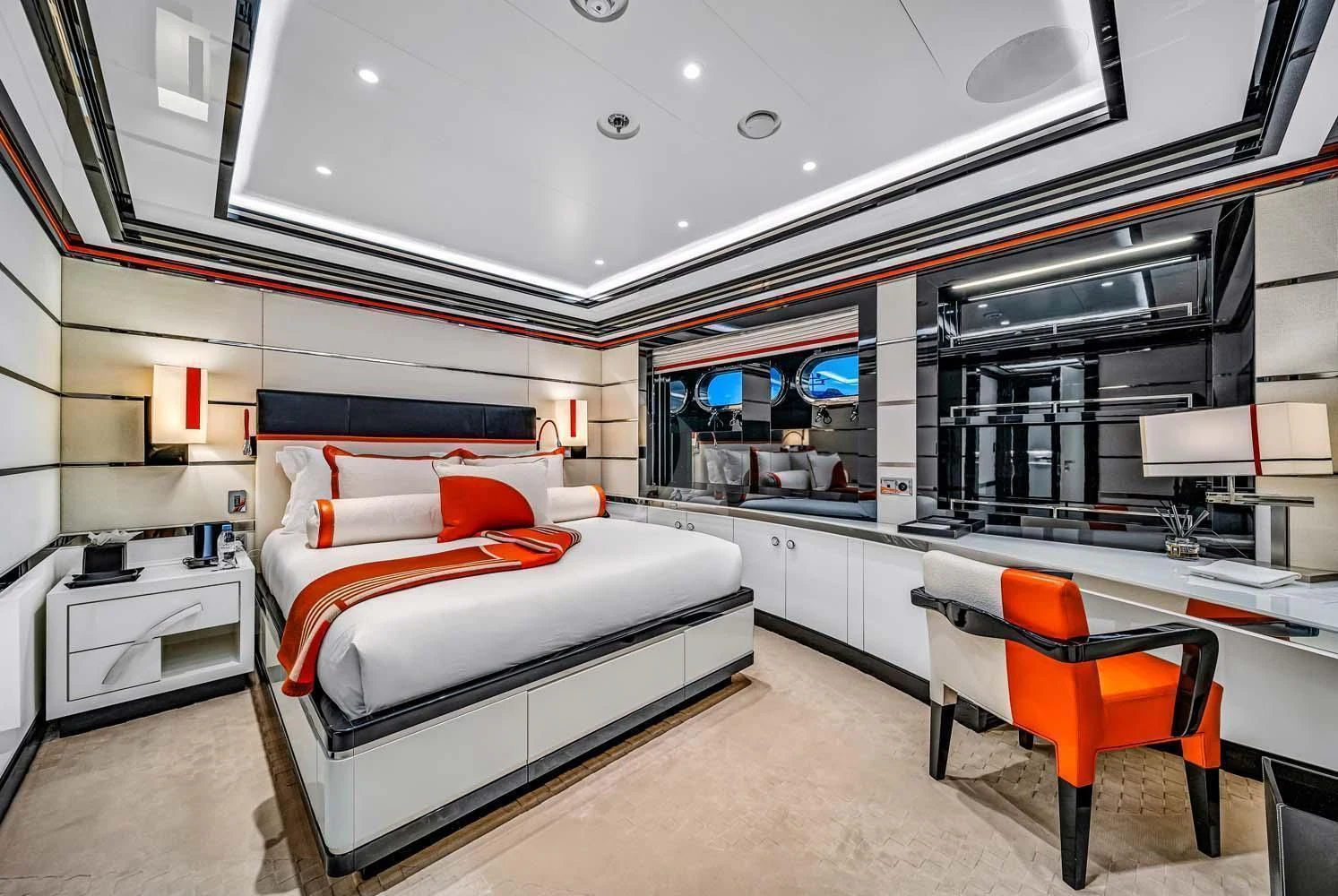 a room with a bed and desk aboard OKTO Yacht for Charter