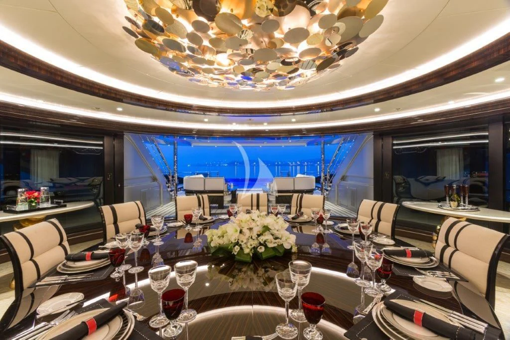 a room with tables and chairs aboard OKTO Yacht for Charter