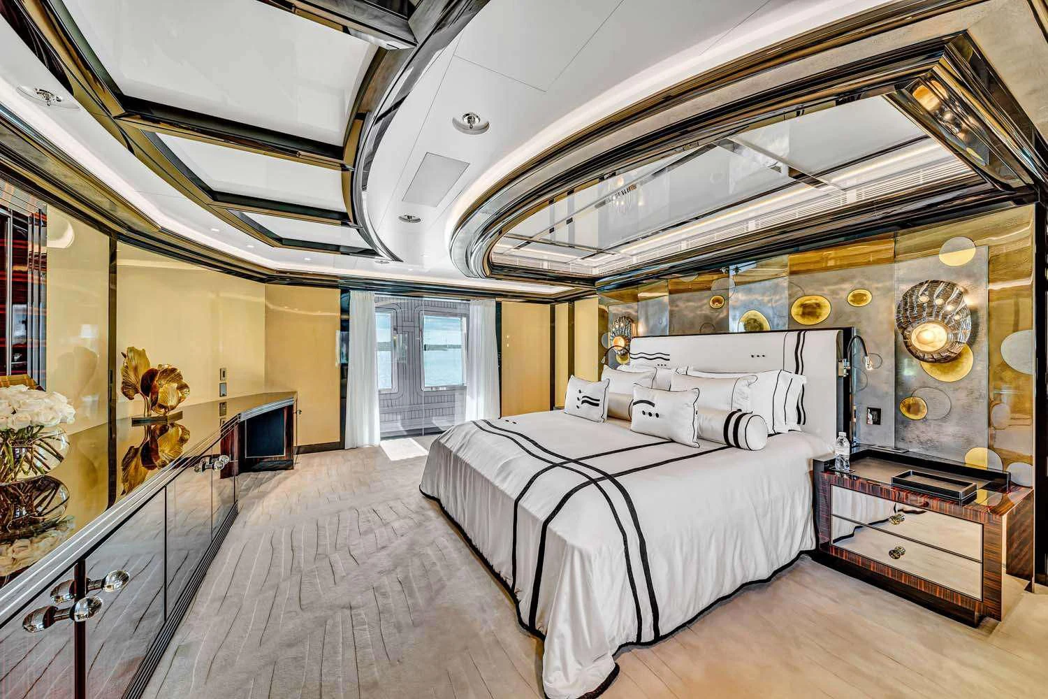 a room with a bed and a desk aboard OKTO Yacht for Charter