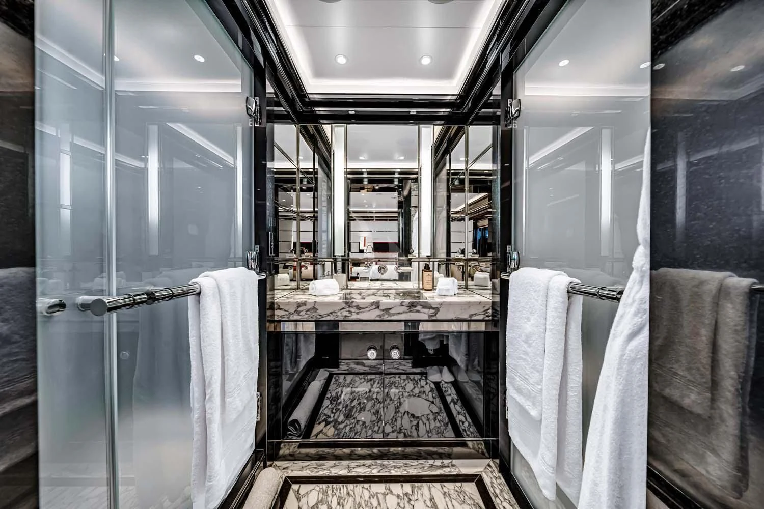 a bathroom with a glass shower aboard OKTO Yacht for Charter