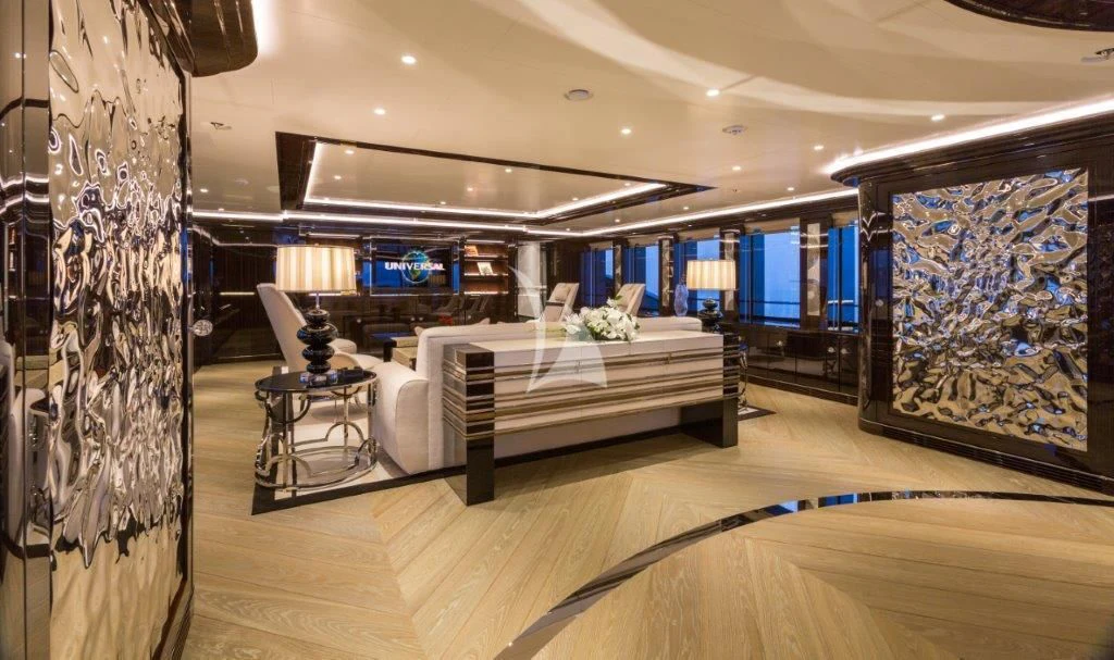 a room with a large bed and a large painting aboard OKTO Yacht for Charter