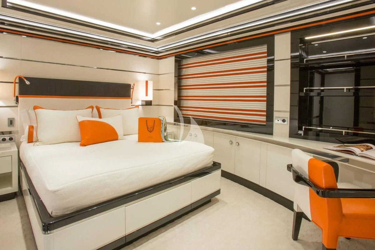 a room with a bed and a chair aboard OKTO Yacht for Charter