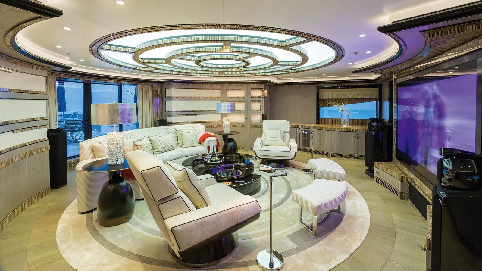 a large living room with a large screen aboard OKTO Yacht for Charter