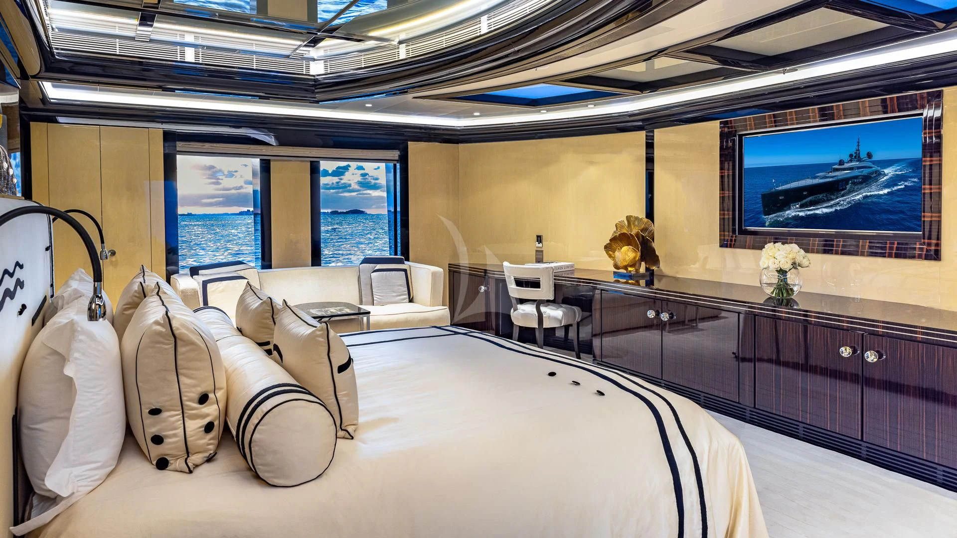 a room with a bed and a large window aboard OKTO Yacht for Charter