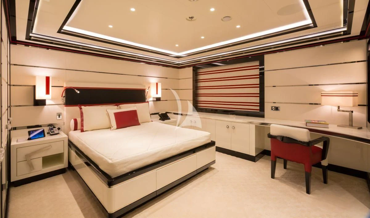a room with a bed and desk aboard OKTO Yacht for Charter
