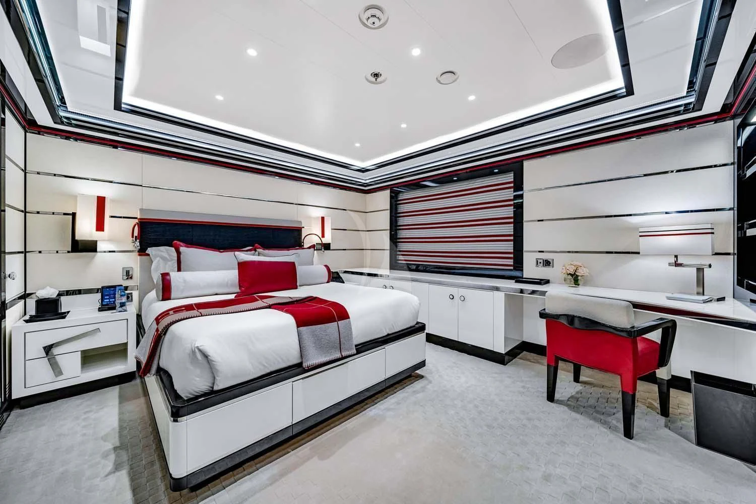 a room with a bed and a desk aboard OKTO Yacht for Charter