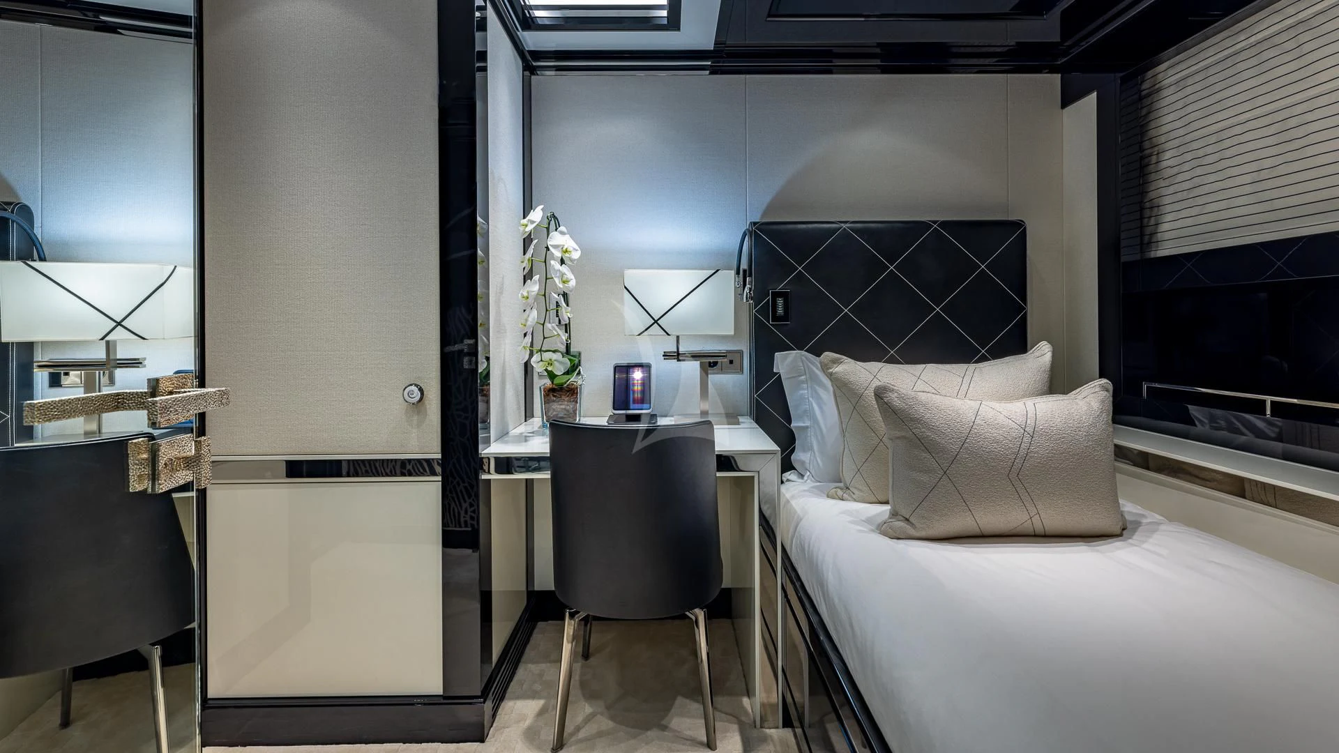 a room with a couch and a table and a tv aboard OKTO Yacht for Charter