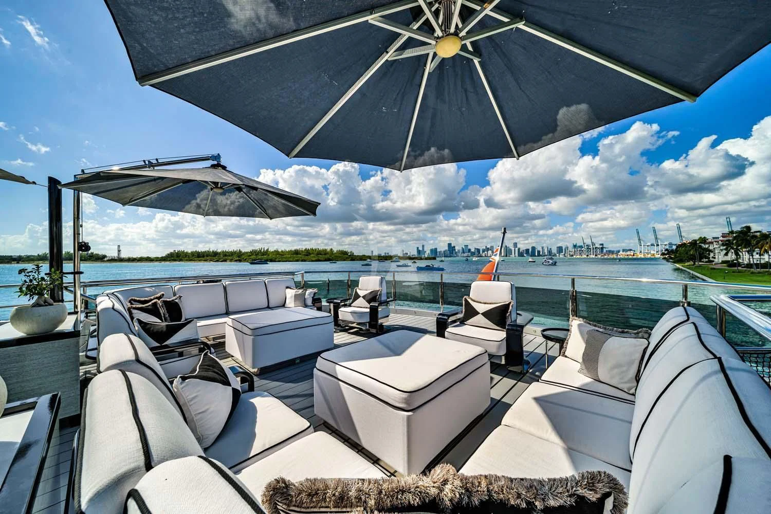 a deck with a view of a city and water aboard OKTO Yacht for Charter