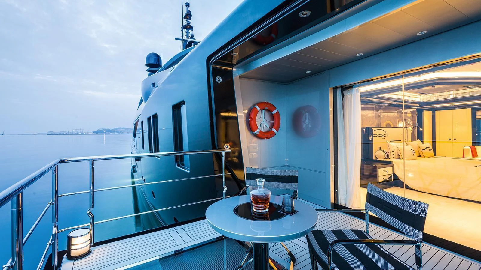a balcony with a table and chairs aboard OKTO Yacht for Charter