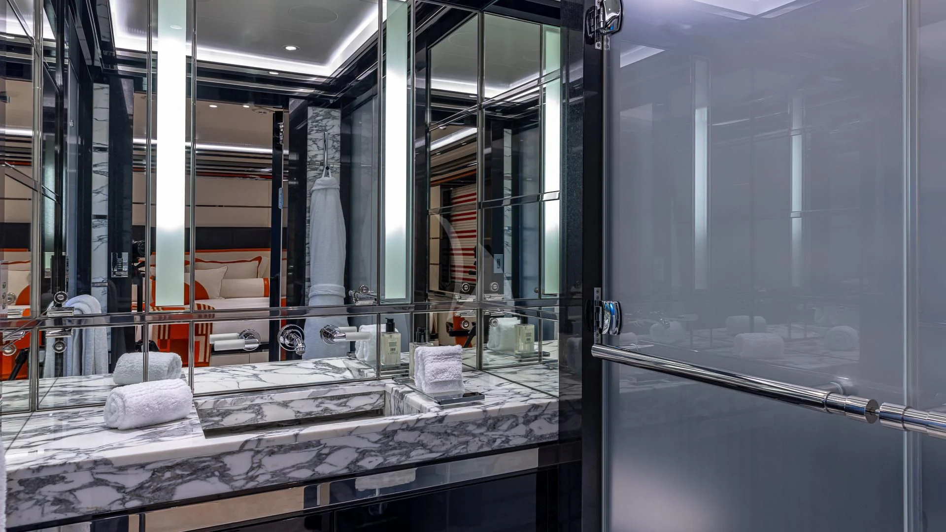 a room with glass walls and a large mirror aboard OKTO Yacht for Charter