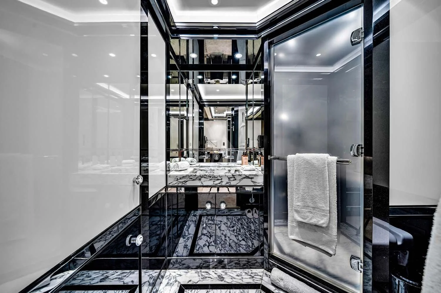 a bathroom with a glass shower aboard OKTO Yacht for Charter
