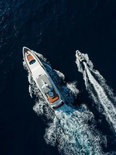 a space shuttle flying over a planet aboard SOLEMATES Yacht for Sale