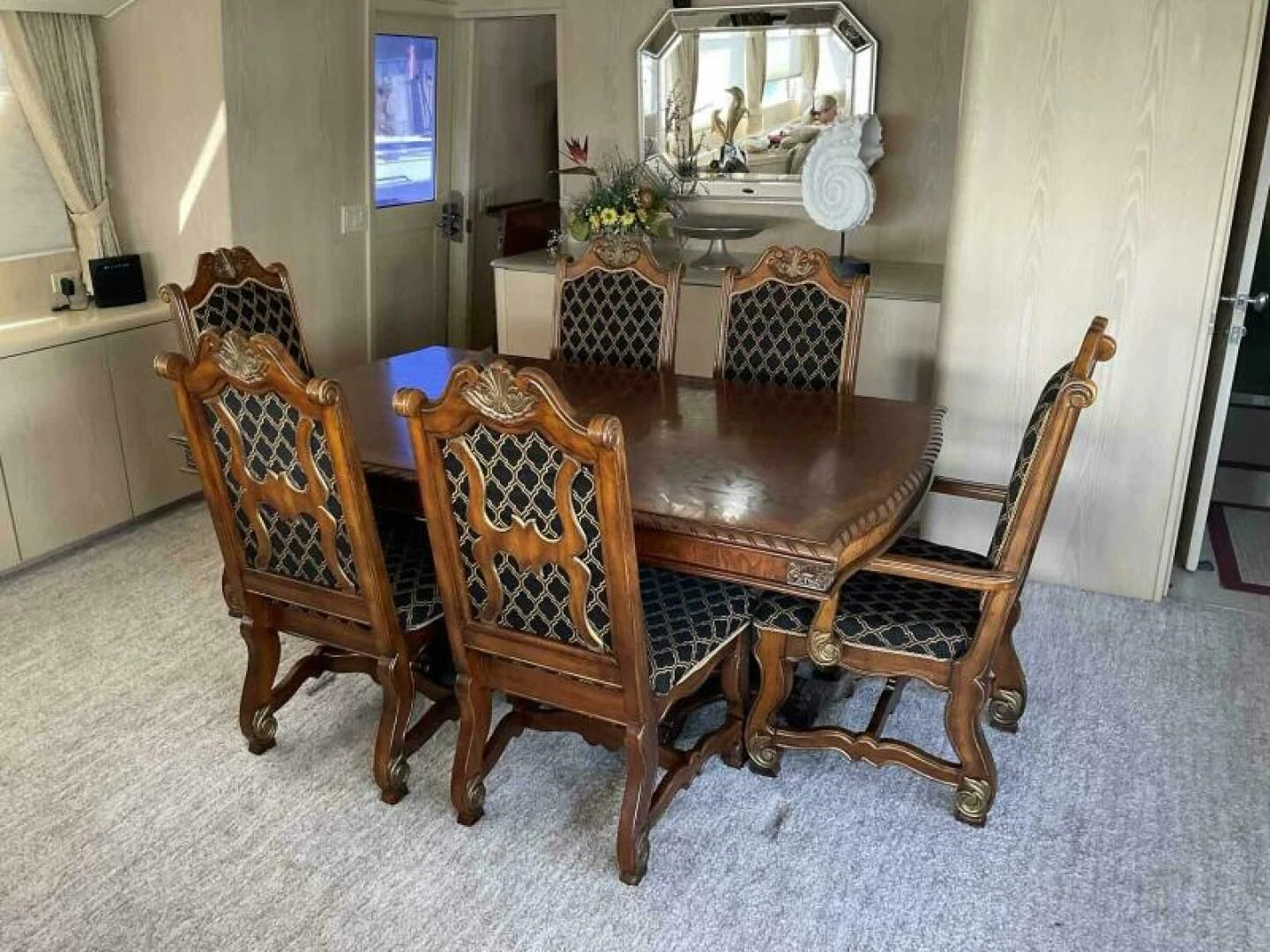 a dining table and chairs aboard MON SHERI Yacht for Sale