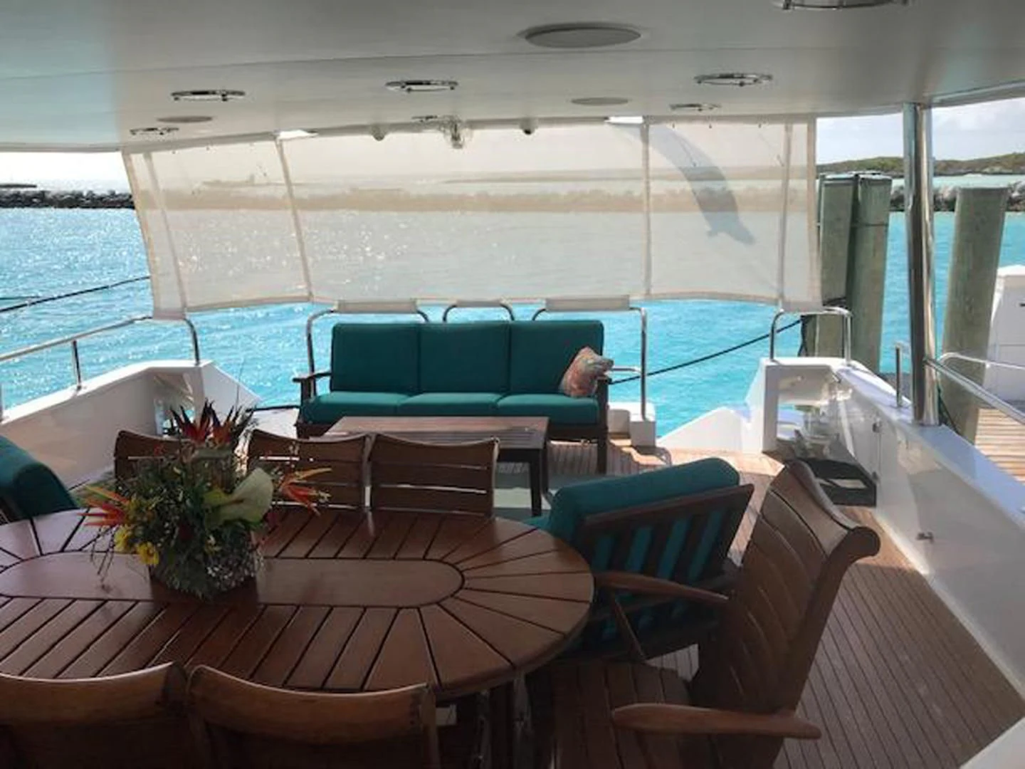 a boat with a table and chairs aboard MON SHERI Yacht for Sale