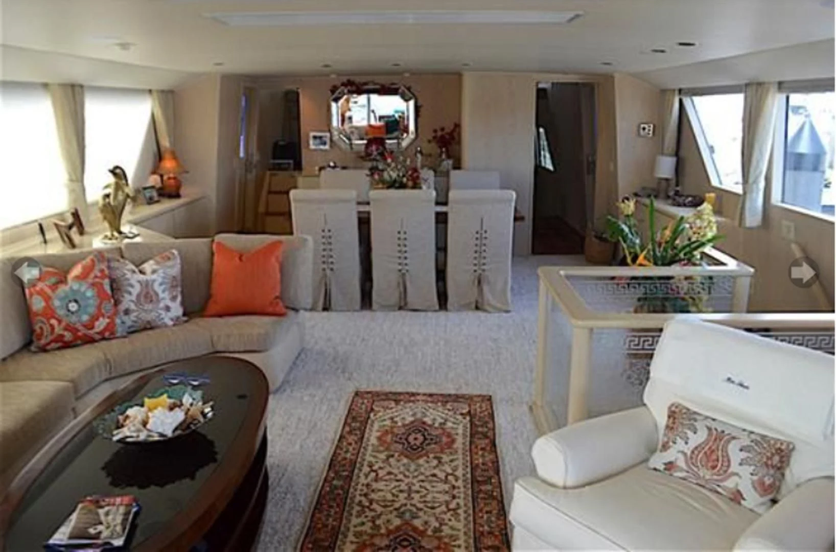 a living room with a couch and a table aboard MON SHERI Yacht for Sale