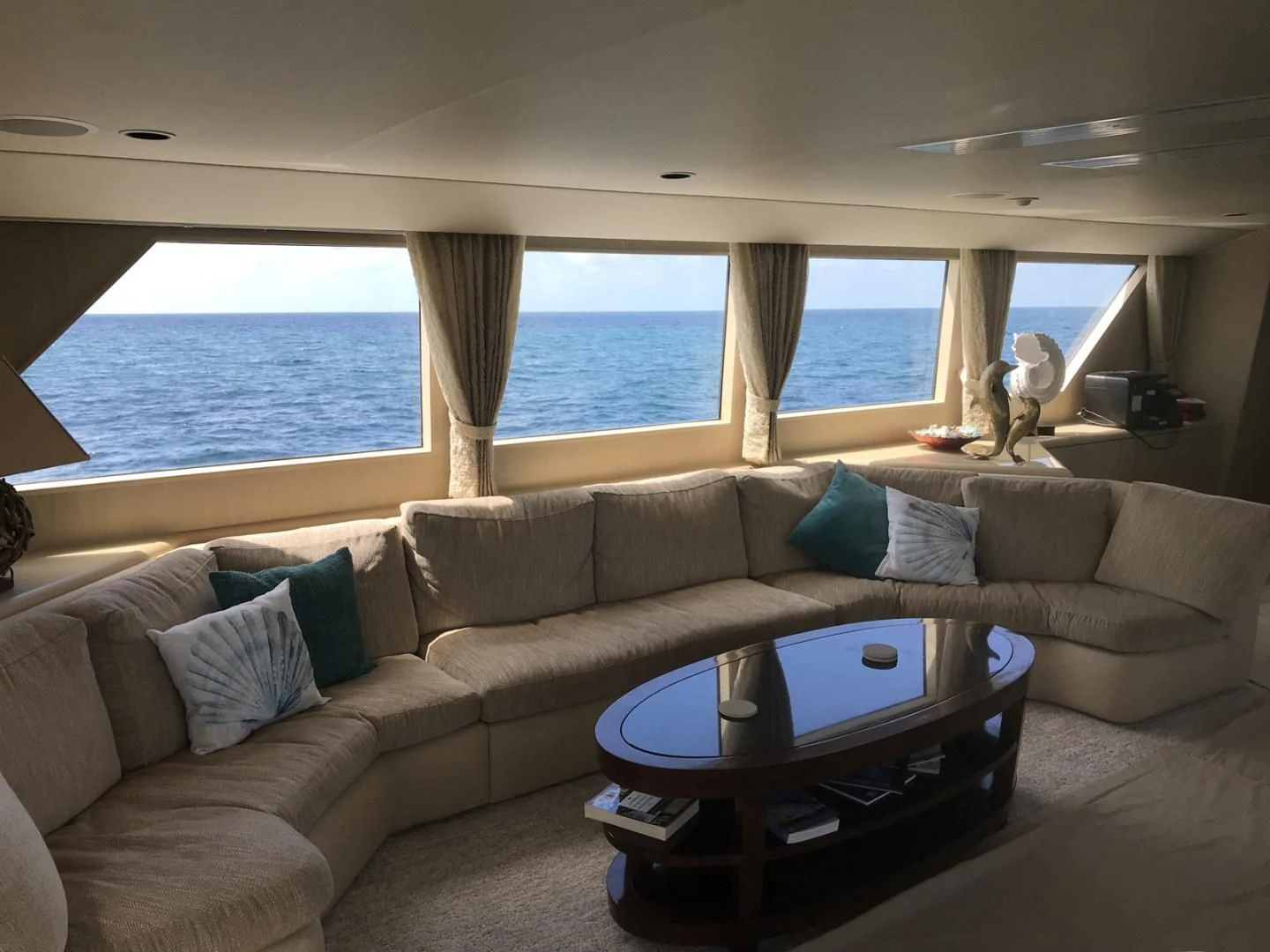a living room with a couch and a table aboard MON SHERI Yacht for Sale