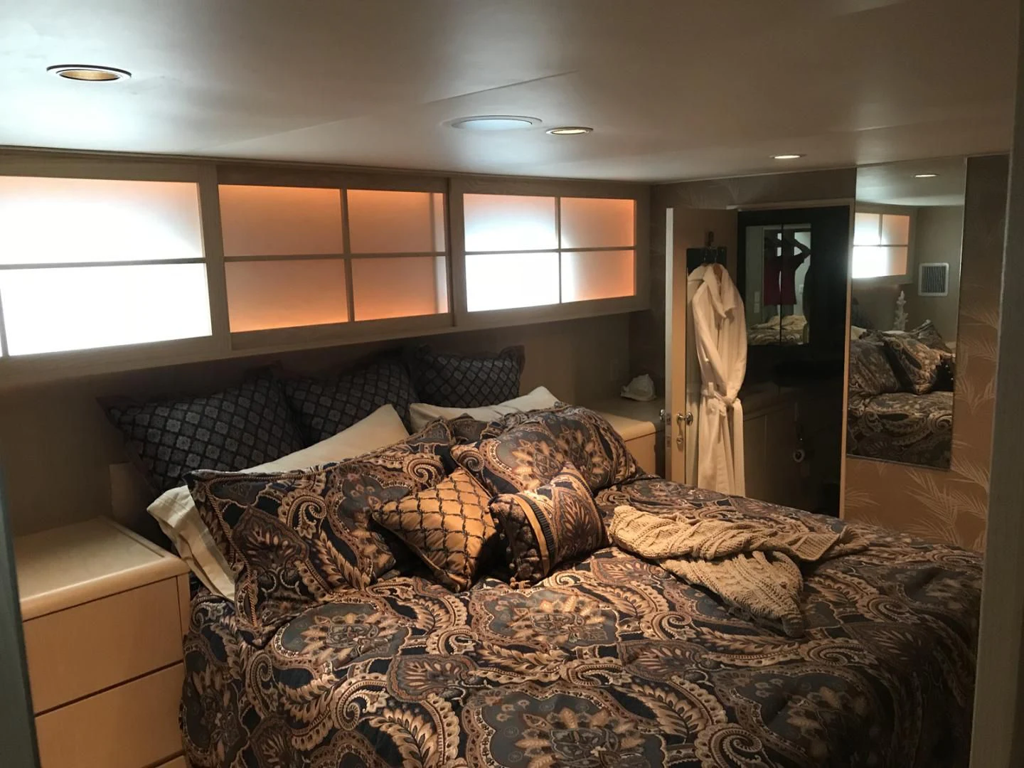 a bedroom with a bed and a mirror aboard MON SHERI Yacht for Sale
