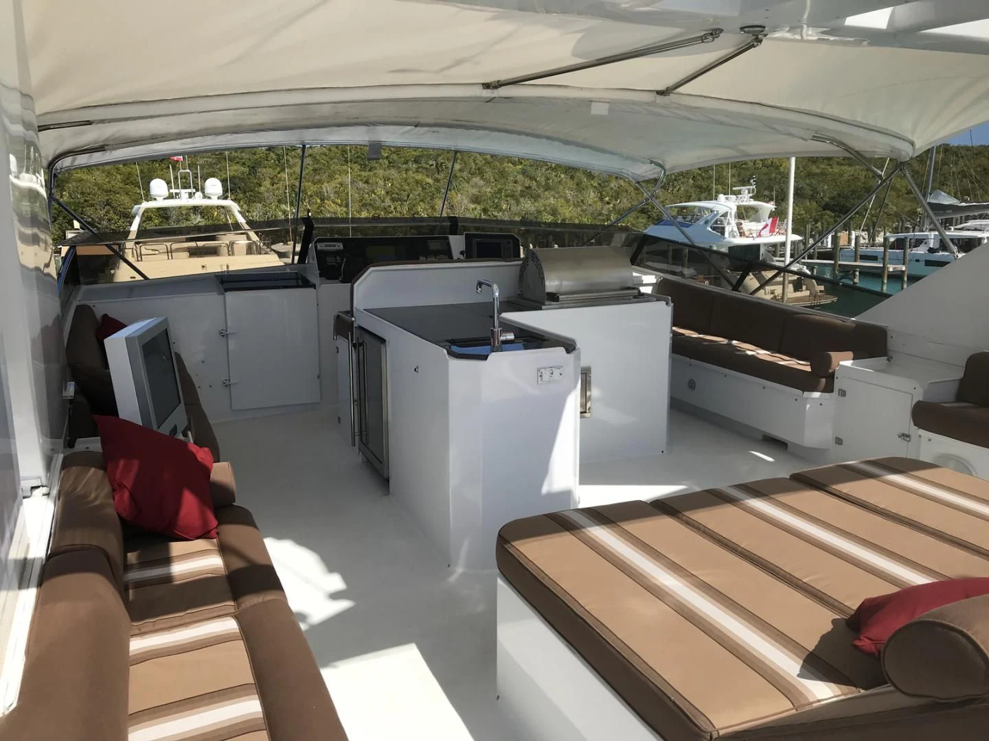a boat with a deck and a deck with a view of the water aboard MON SHERI Yacht for Sale