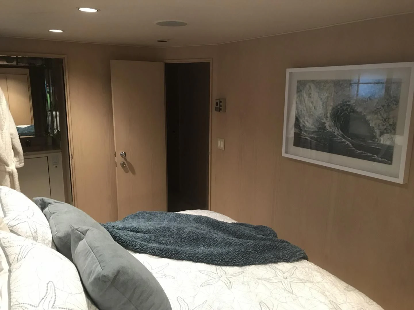a bedroom with a bed and a painting on the wall aboard MON SHERI Yacht for Sale