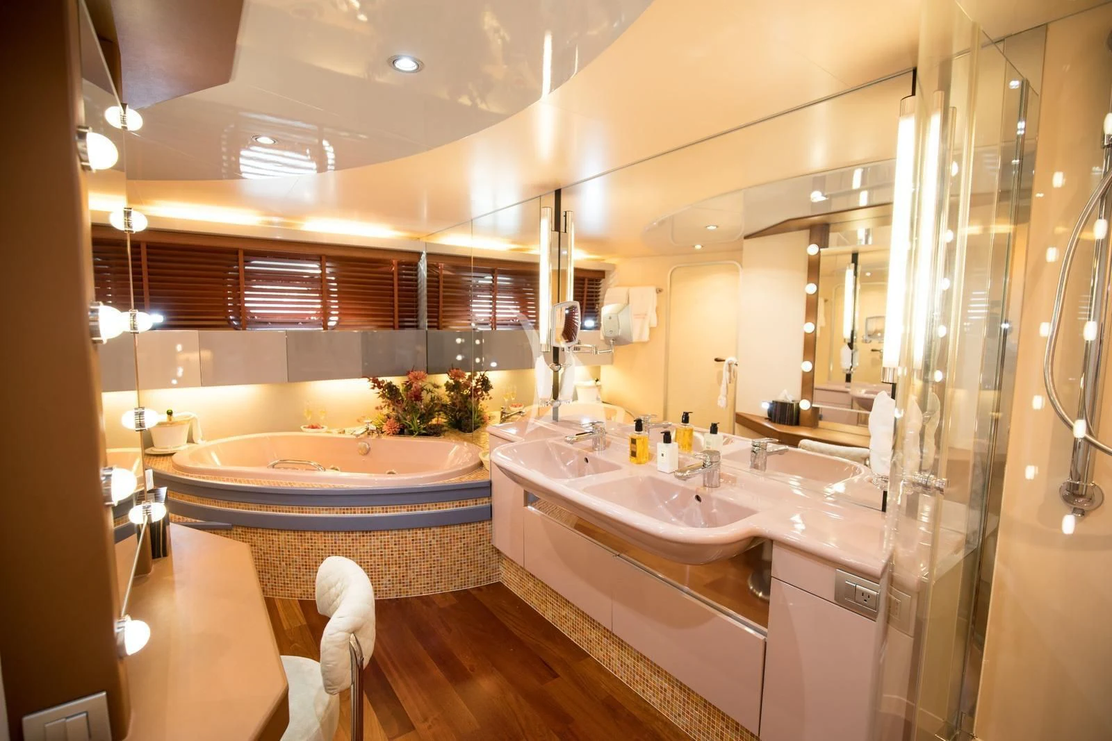 a bathroom with a tub sink and a large mirror aboard HEARTBEAT OF LIFE Yacht for Sale