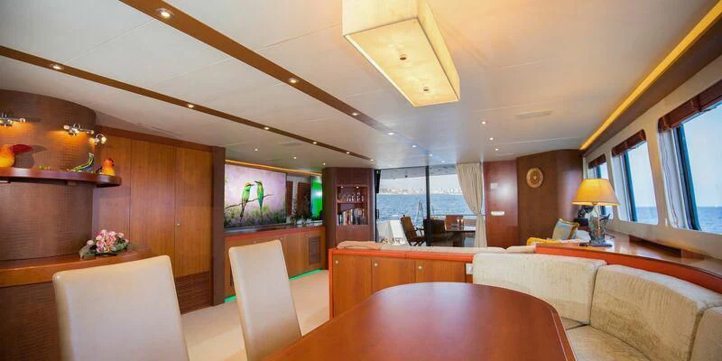 a room with a table and couches aboard HEARTBEAT OF LIFE Yacht for Sale
