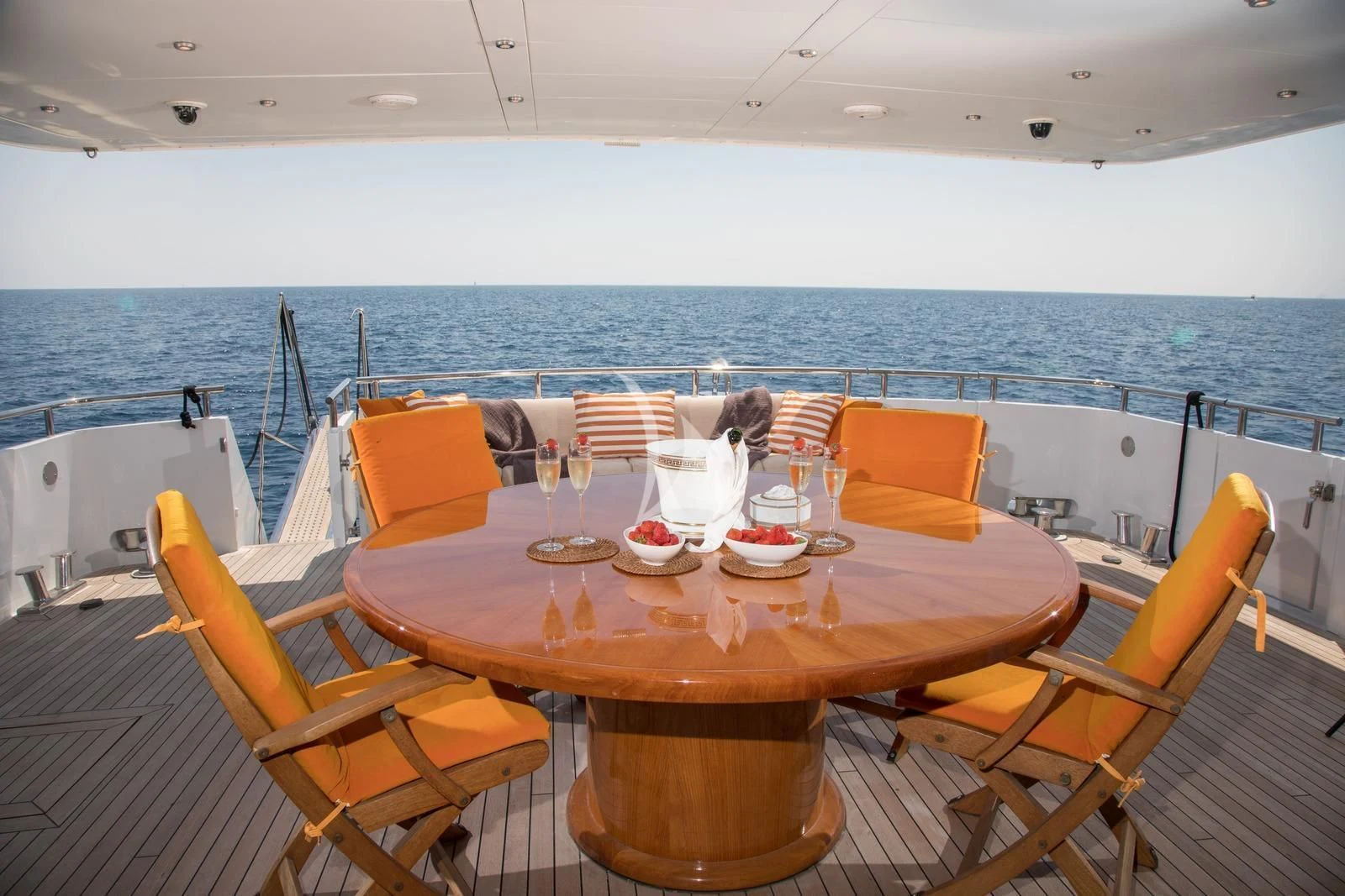 a table set for a meal on a deck overlooking the ocean aboard HEARTBEAT OF LIFE Yacht for Sale