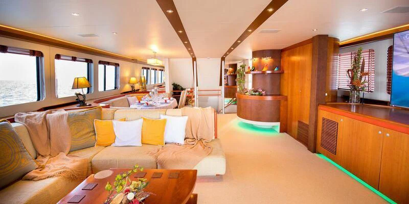 a living room with a couch and a table aboard HEARTBEAT OF LIFE Yacht for Sale