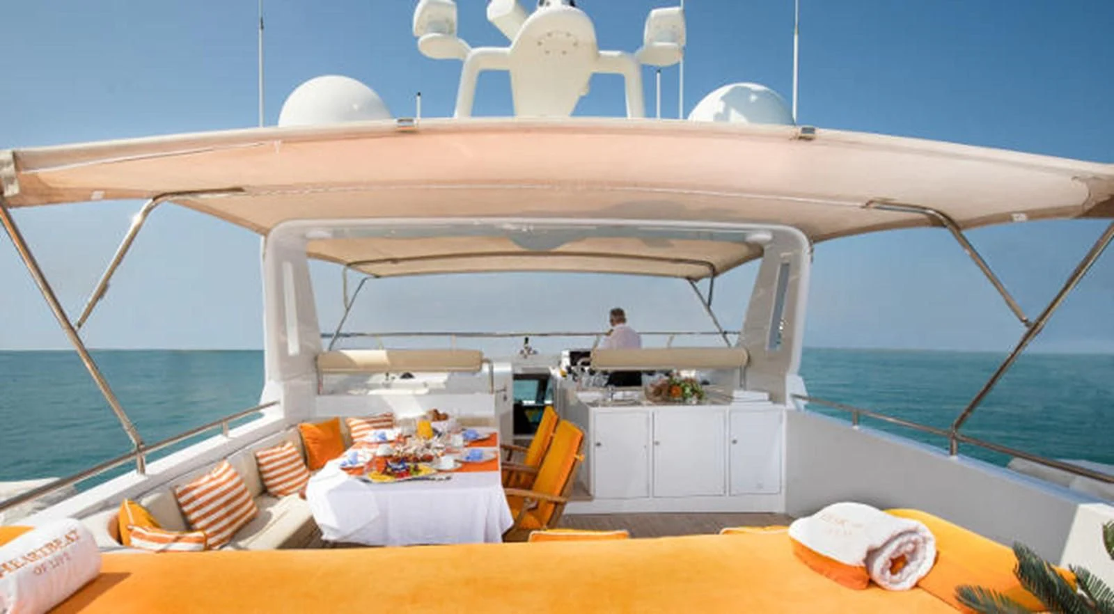 a boat with a table and chairs on the deck aboard HEARTBEAT OF LIFE Yacht for Sale