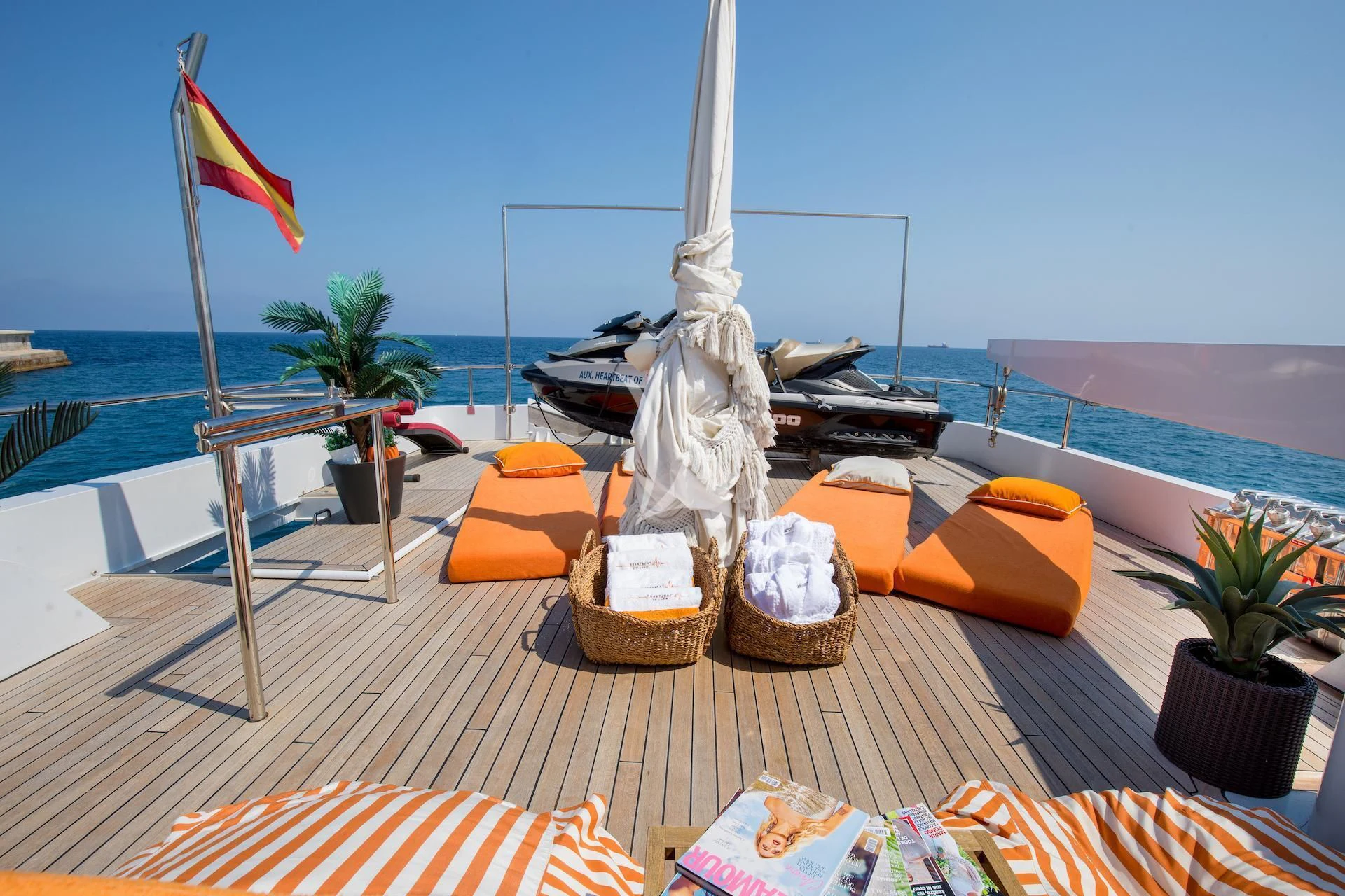 a table with a white and red flag and a white sailboat on it aboard HEARTBEAT OF LIFE Yacht for Sale
