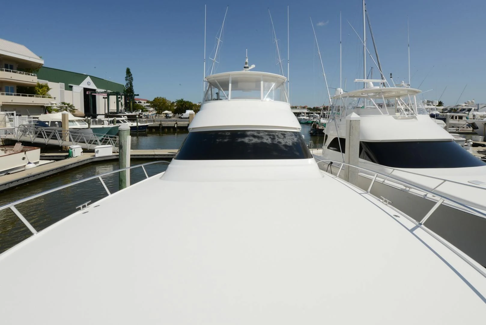 a white yacht in a harbor aboard CRAZY J Yacht for Sale