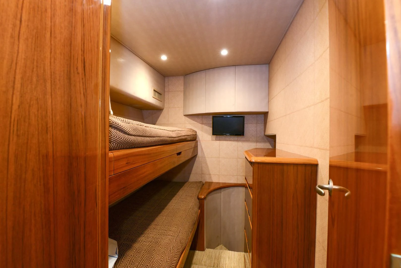 a room with a bed and a television aboard CRAZY J Yacht for Sale