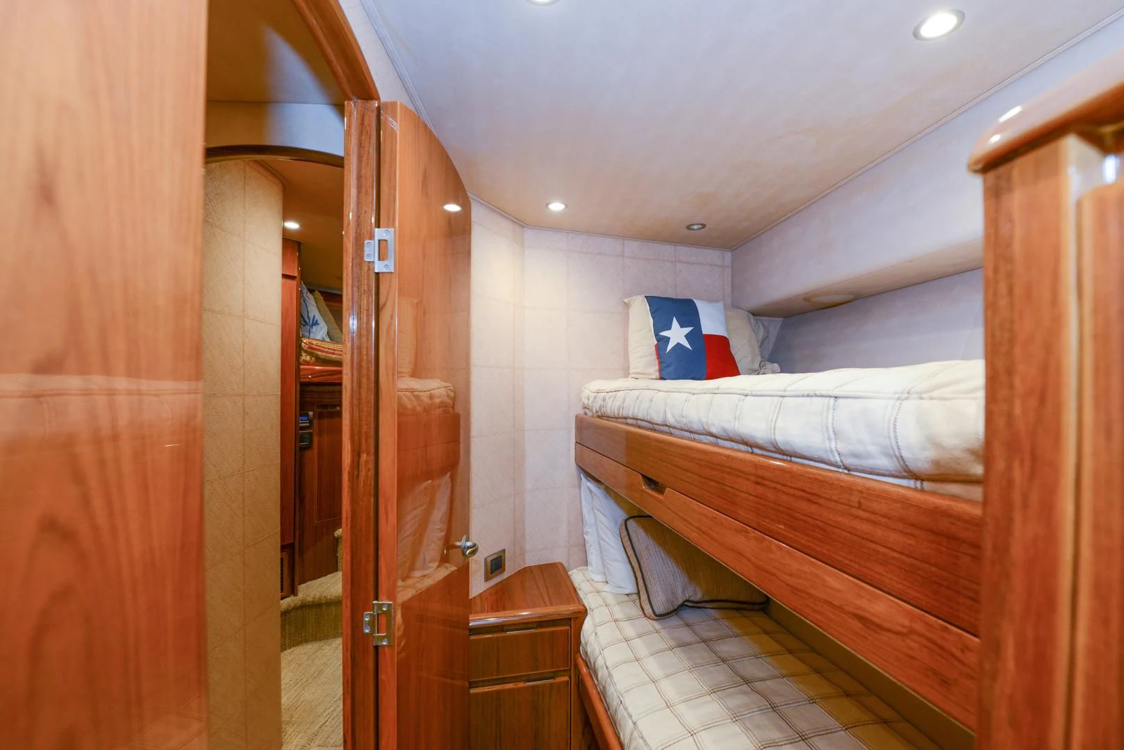 a bedroom with a bed and a door aboard CRAZY J Yacht for Sale