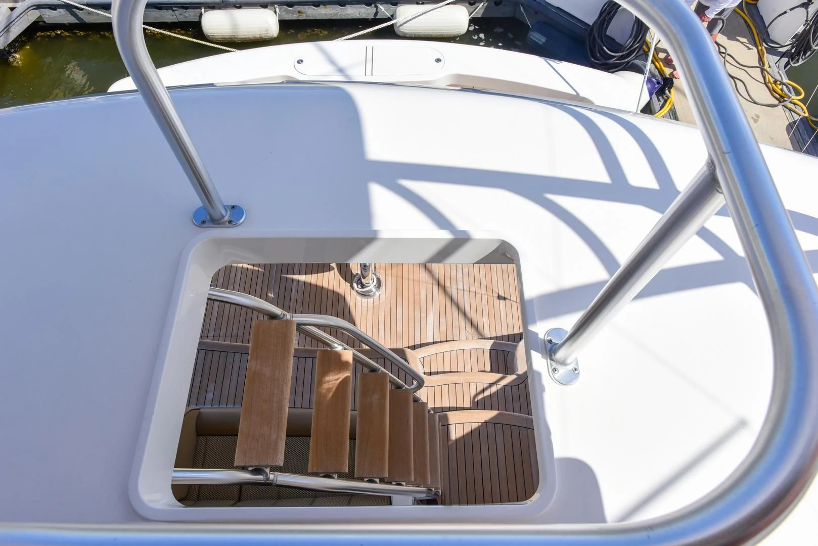 a boat with a wooden deck aboard CRAZY J Yacht for Sale