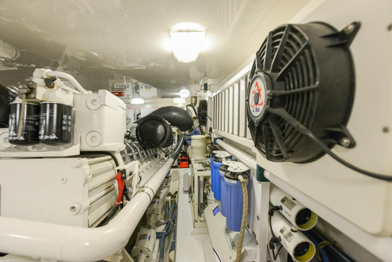 a white car with a large engine aboard CRAZY J Yacht for Sale