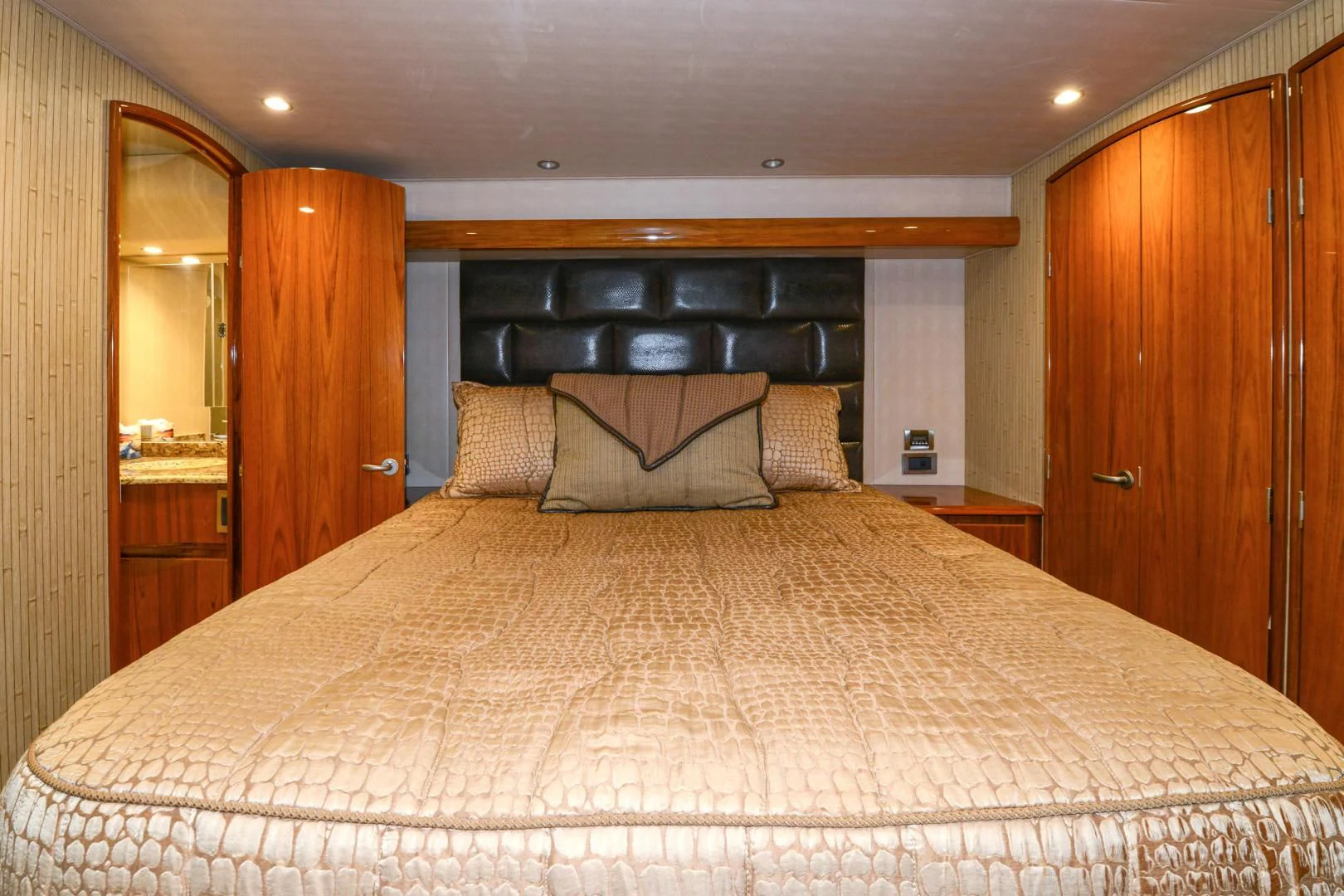 a bed with a white comforter aboard CRAZY J Yacht for Sale