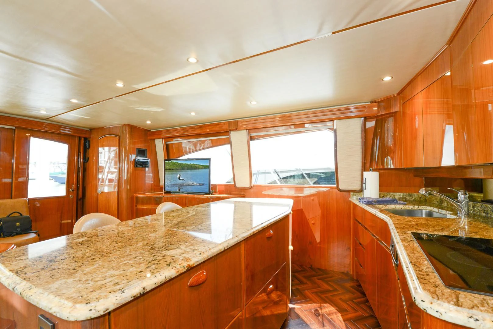 a kitchen with wooden cabinets aboard CRAZY J Yacht for Sale