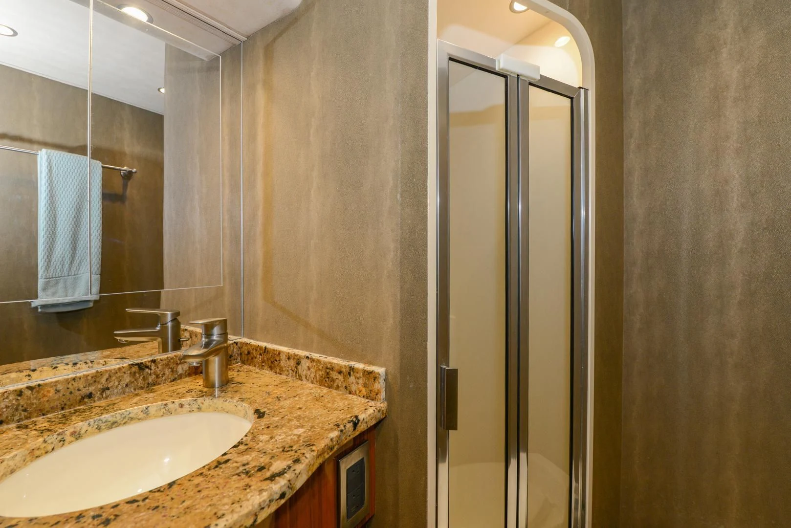 a bathroom with a sink and a shower unit aboard CRAZY J Yacht for Sale