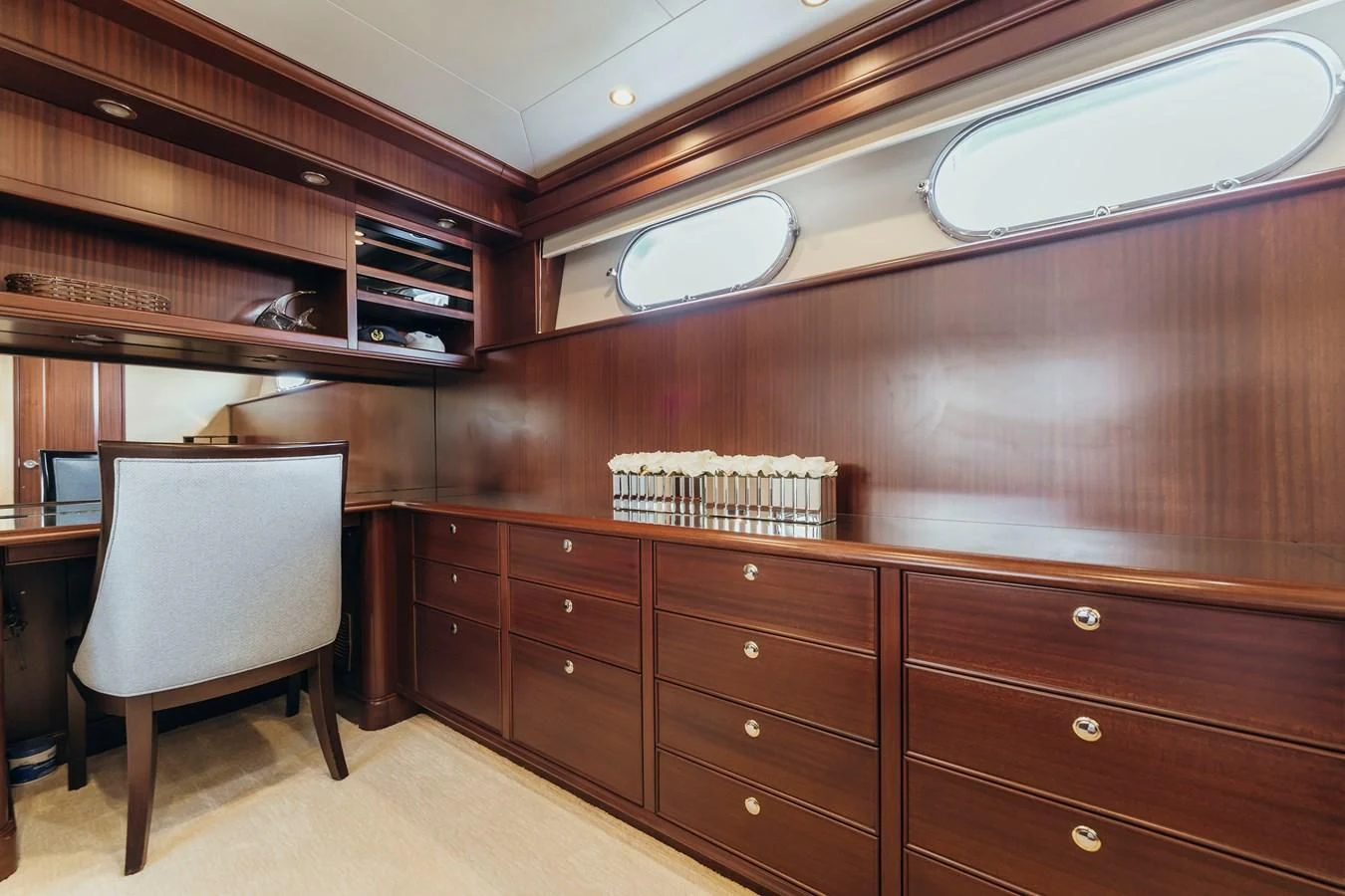 a room with wooden cabinets and a chair and a desk with Robie House in the background aboard FINAL FINAL Yacht for Sale