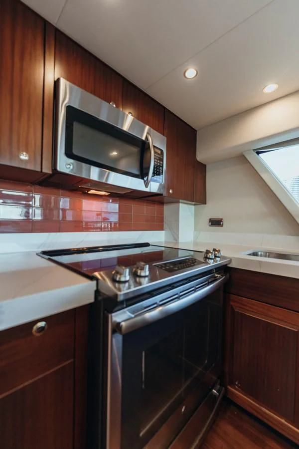a kitchen with wooden cabinets aboard FINAL FINAL Yacht for Sale