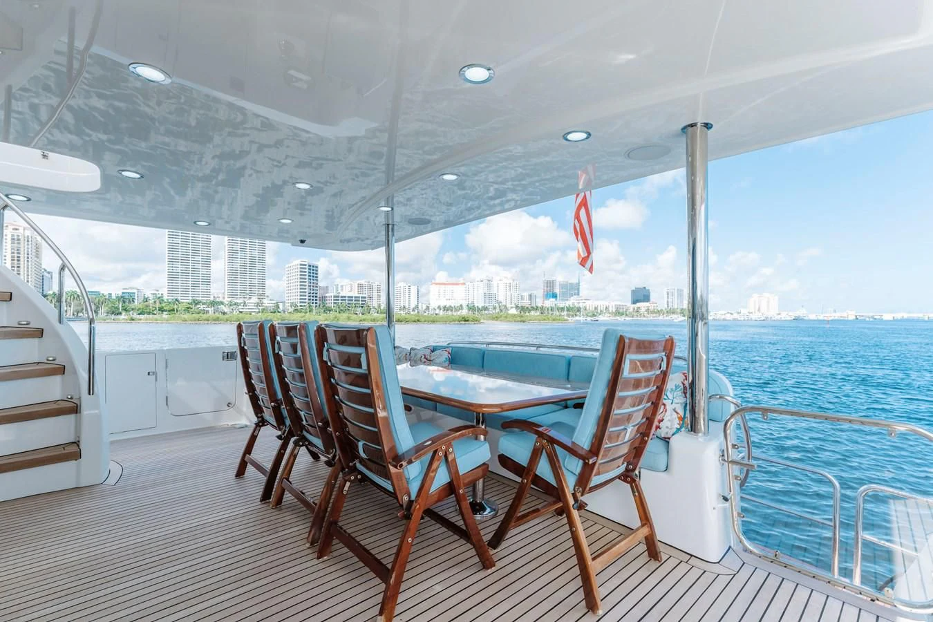 a deck with chairs and a table on it aboard FINAL FINAL Yacht for Sale