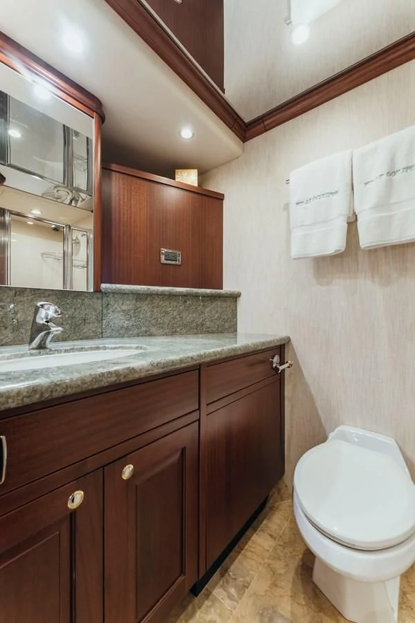a bathroom with a toilet and a sink aboard FINAL FINAL Yacht for Sale