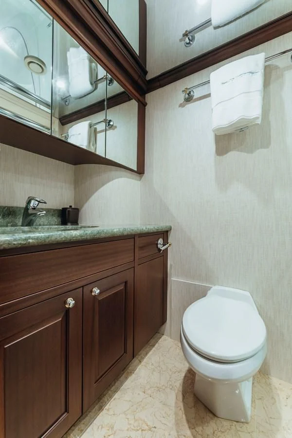 a bathroom with a toilet and a sink aboard FINAL FINAL Yacht for Sale