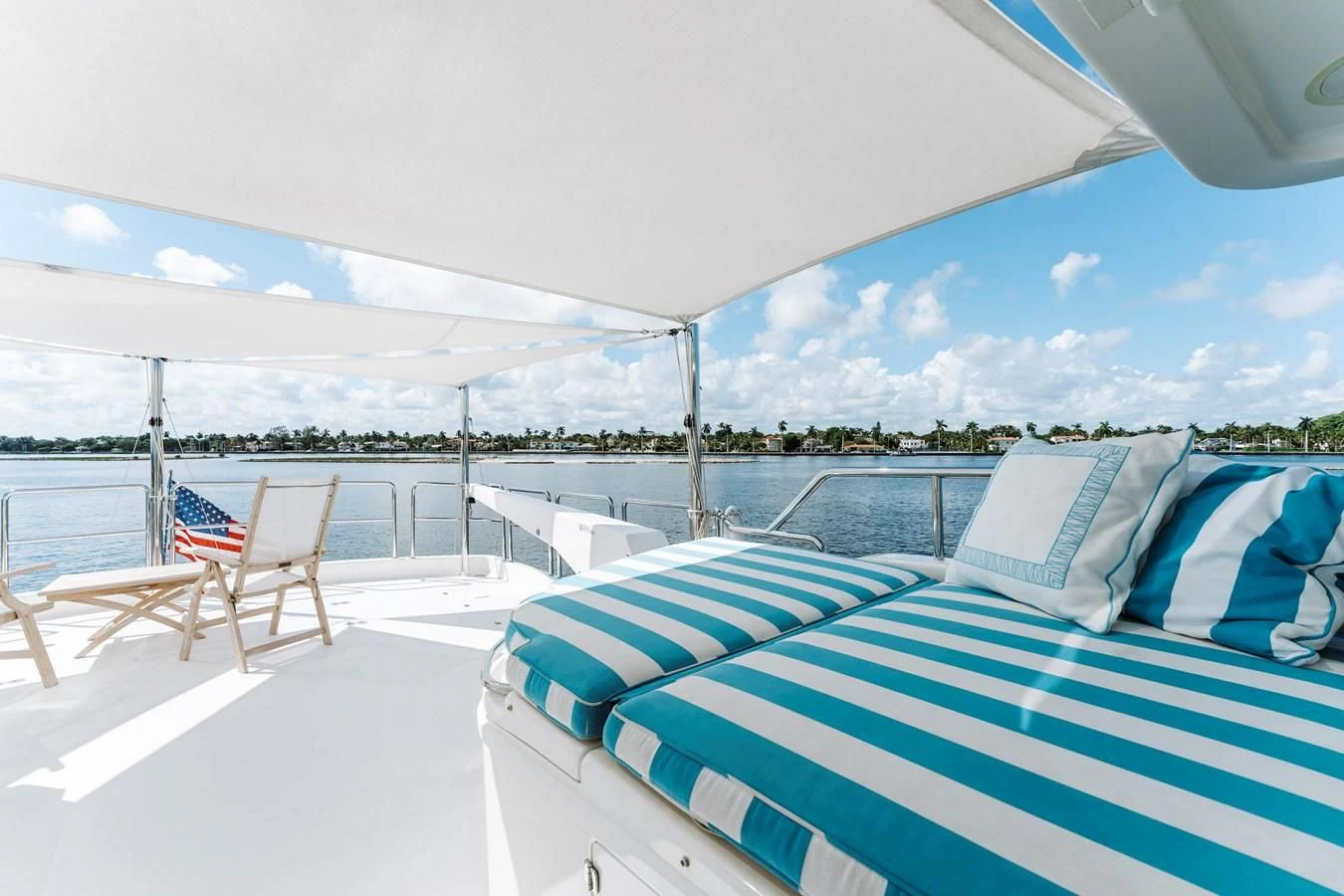 a lounge area with chairs and umbrellas aboard FINAL FINAL Yacht for Sale