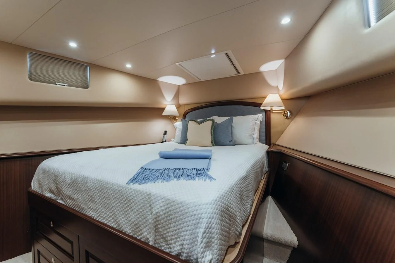 a room with a bed and a lamp aboard FINAL FINAL Yacht for Sale
