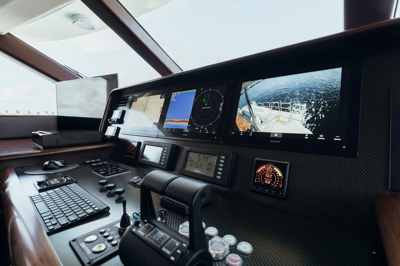 a person's hand holding a computer monitor with a keyboard and mouse aboard FINAL FINAL Yacht for Sale
