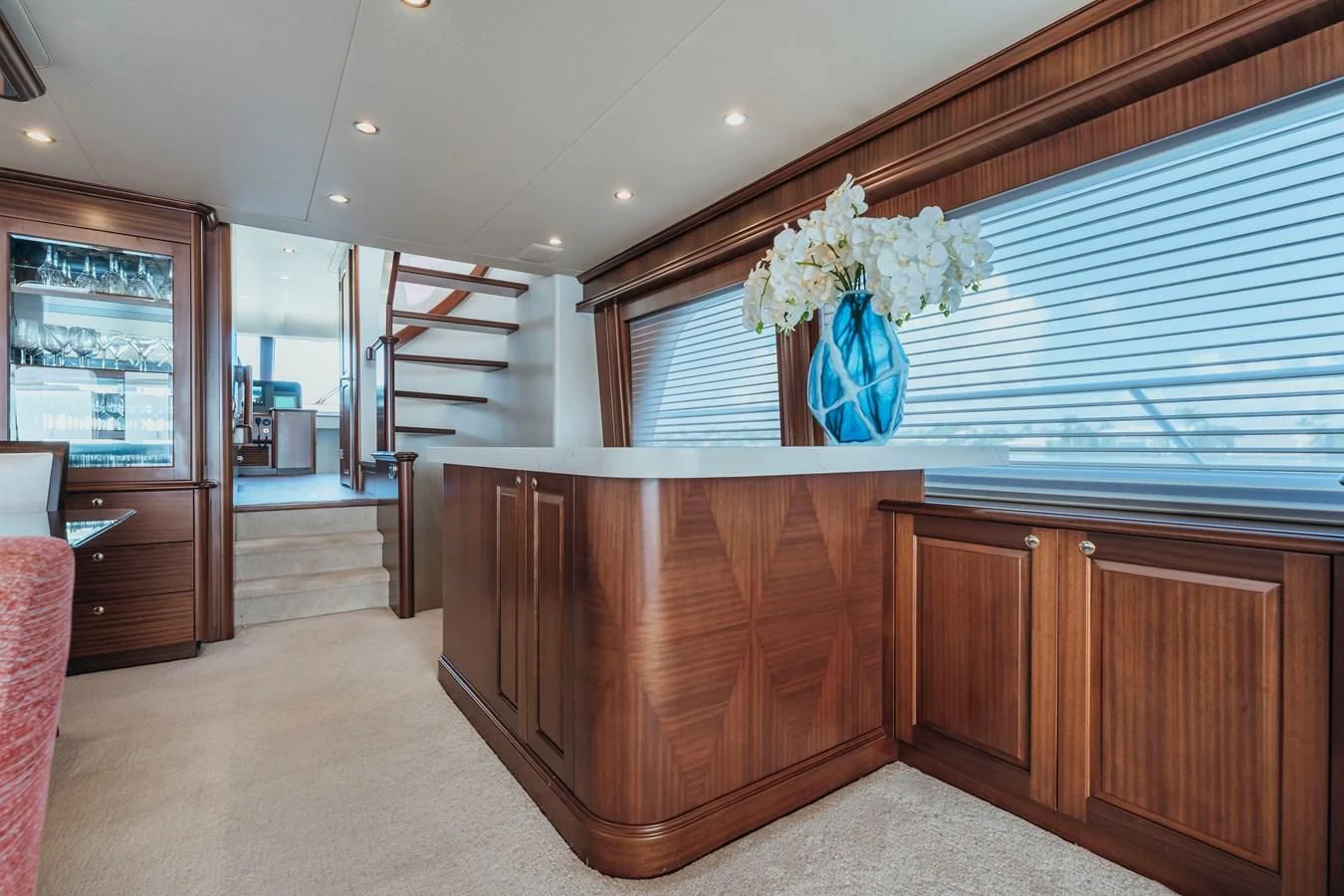a large room with a large blue vase with flowers in it aboard FINAL FINAL Yacht for Sale