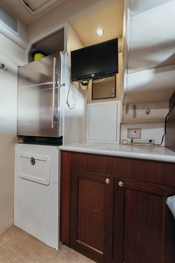 a kitchen with a microwave and a refrigerator aboard FINAL FINAL Yacht for Sale