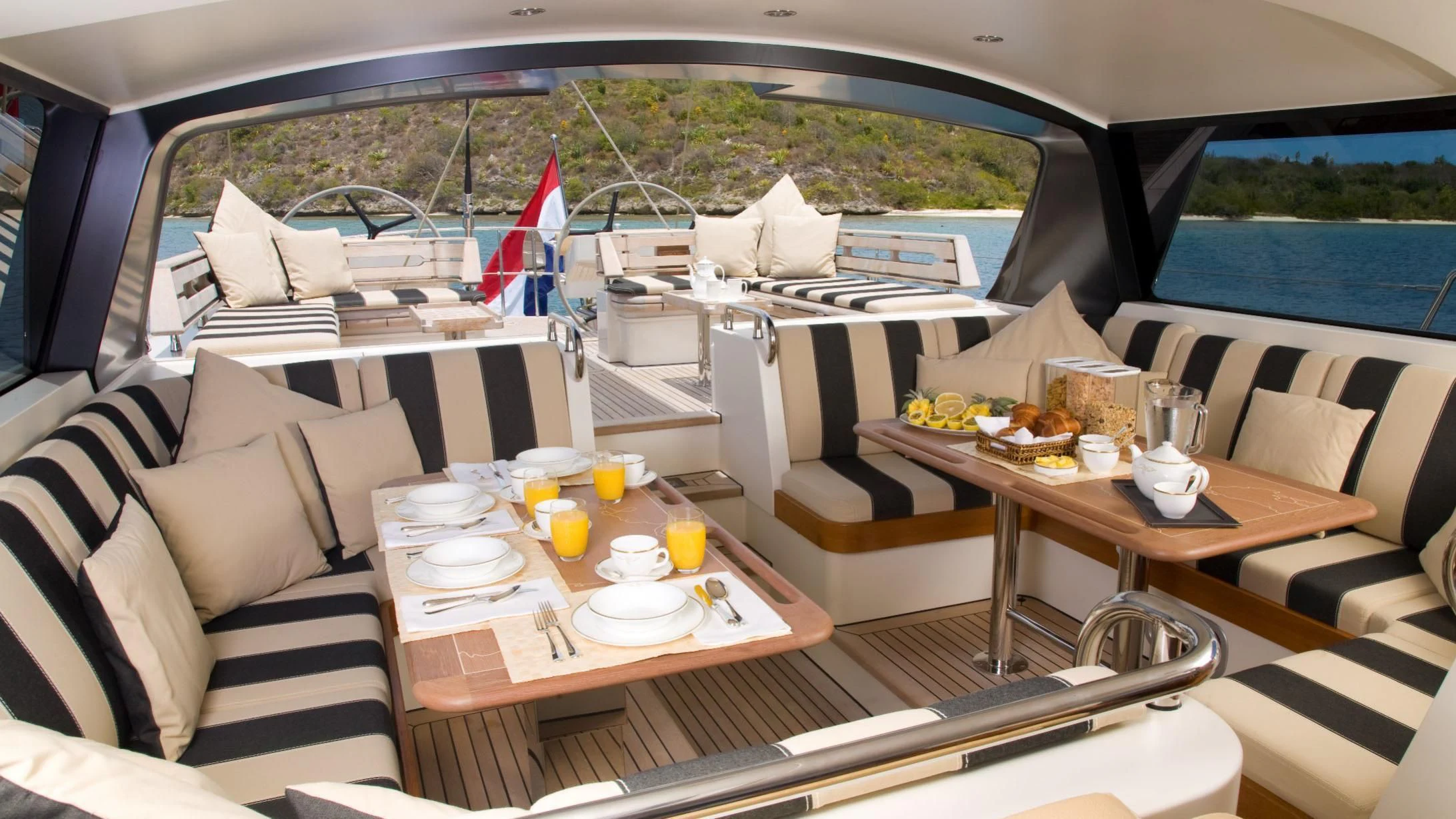 a boat with a table and chairs aboard ICARUS Yacht for Sale