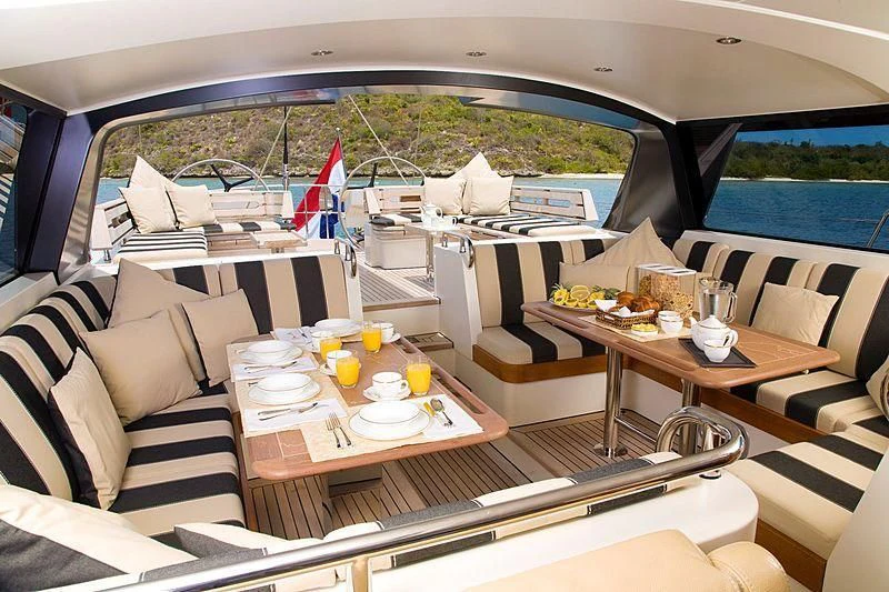 a boat with a table and chairs aboard ICARUS Yacht for Sale