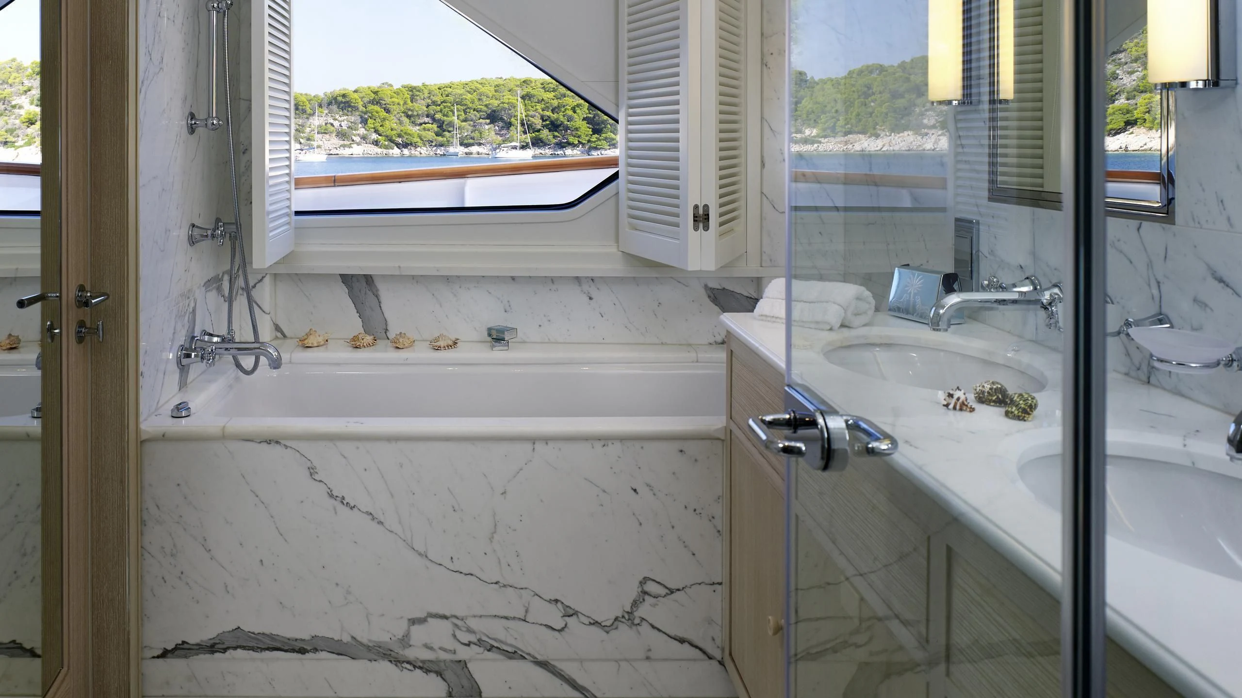 a bathtub with a sink and a window aboard ANCALLIA Yacht for Sale